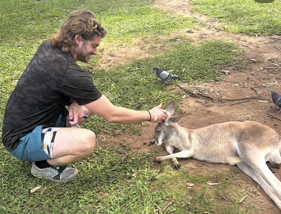 Ian comforting a kangaroo at a rescue facility in Australia.